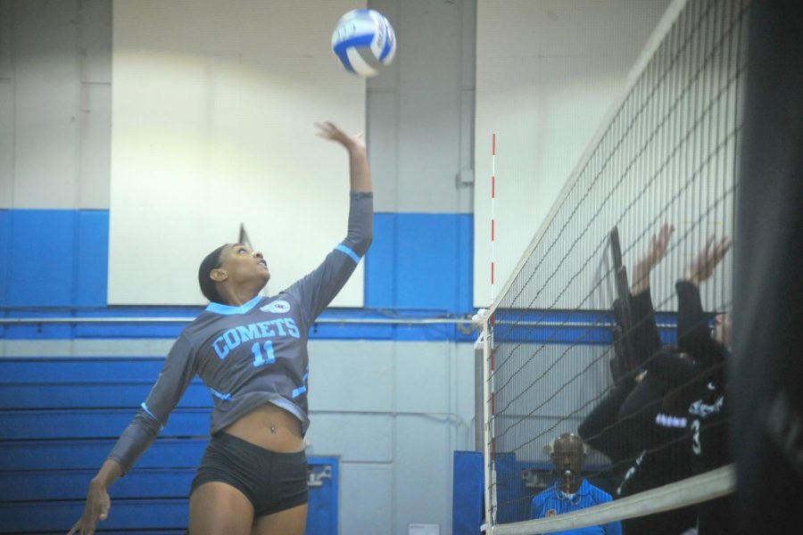 Comet middle blocker Makaya Thomas hits the ball over the net in Friday’s loss against College of Alameda in the Gymnasium. 