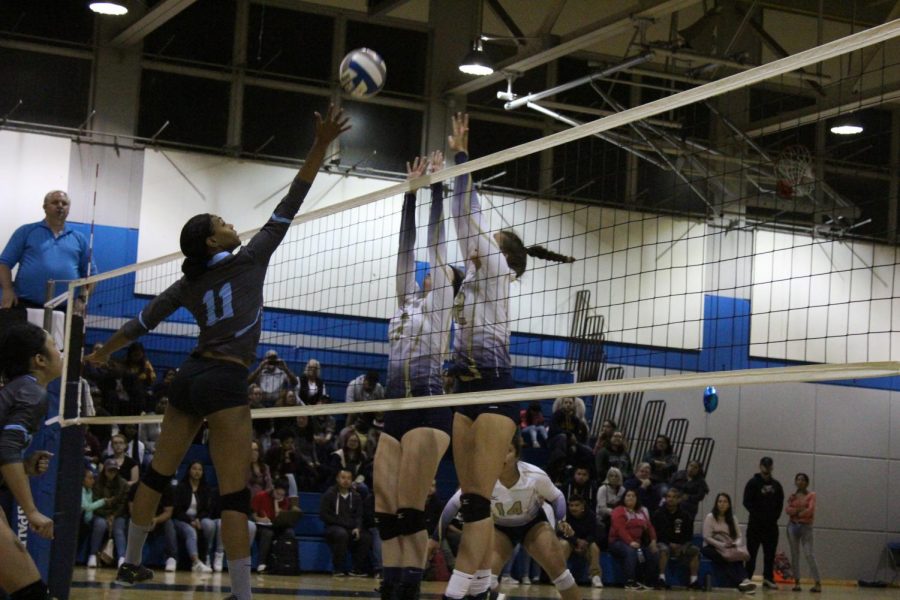 Middle blocker Makaya Thomas makes a shot attempt over two Yuba College defenders on Sophomore Night in the Gymnasium 