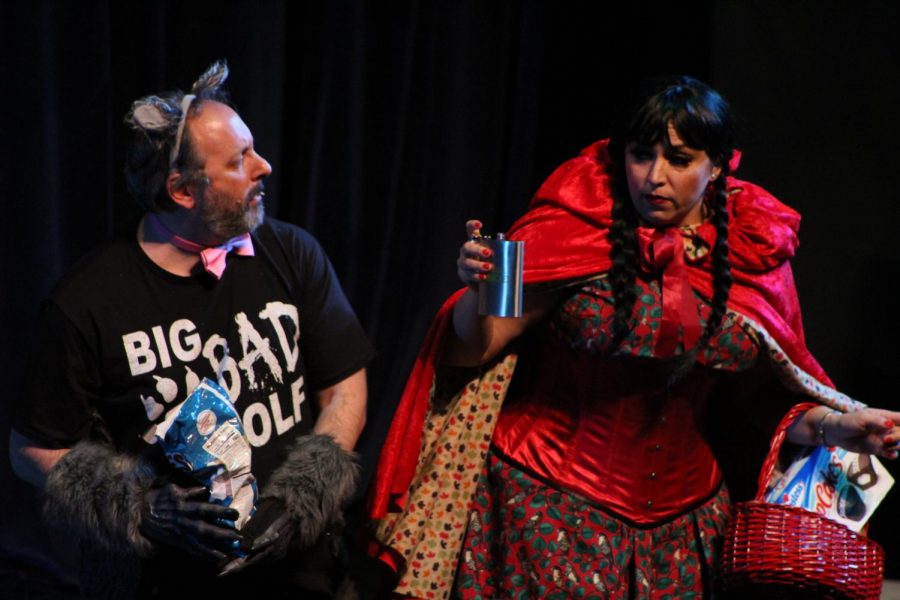Liberal arts Dean Jason Berner (left) as the Big Bad Wolf is offered alcohol by Little Red Riding Hood played by Theater Staging Specialist Courtney Johnson during Twisted Tale in the Knox Center on Friday