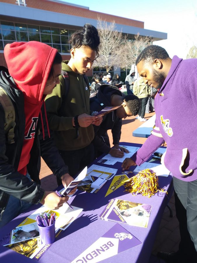 Two students discuss the application and transfer process with Benedict College representative during the HBCU Caravan at the Campus Center Plaza on Feb. 6.