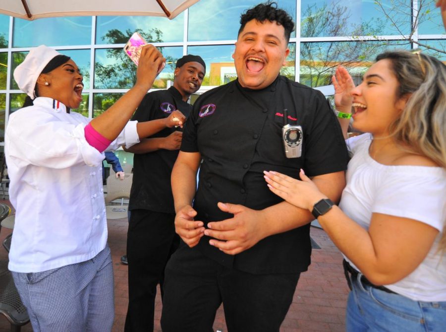 Culinary arts major Robin Jassa (middle right), Kassane Clay (left), Brandon Williams (middle left) and Elizabeth Razo, celebrate Jassa as he wins a scholarship for a trip to Italy at the Food and Wine event on Sunday. 