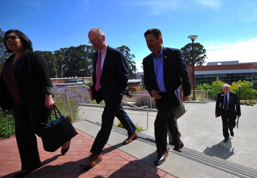 State Chancellor Eloy Ortiz Oakley (middle left)
walks to the GE Building with his staff after meeting with CCC faculty 
in Fireside Hall during his visit  Monday.  