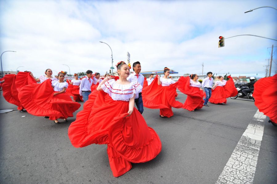 Mexican folk dancers perform a dance routine at the intersection of Macdonald Avenue and 23rd Street during the 15th annual Unity and Peace Parade on May 4, 2019 in Richmond, California. 
