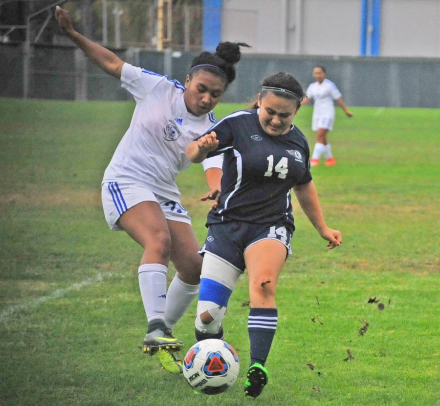 Comet defender Ashley Portillo (right) battles for possession of the ball during a home game in the 2017 season, the last time the women’s soccer team played. 