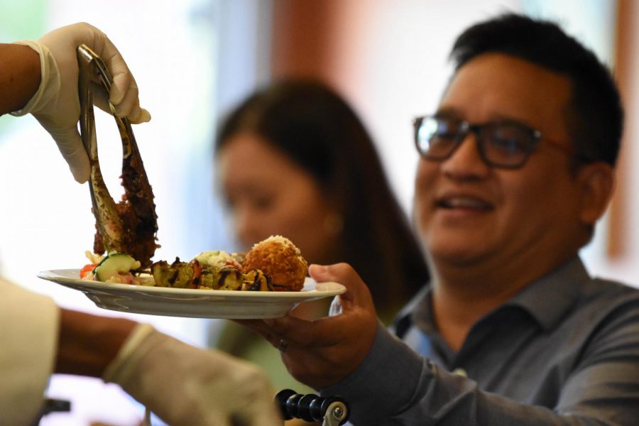 Rodolfo Santos enjoys a plate of the Mediterranean cuisine served during the Iron Chef event held Sept. 5 in Aqua Terra Grill.  