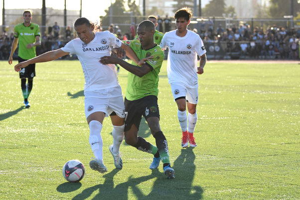Oakland Roots central midfielder Octavio Guzman tackles off FC Juarez striker Diego Rolan for possession of the ball during the 4-2 win for the FC Juarez Bravos in Oakland, California on Sunday.