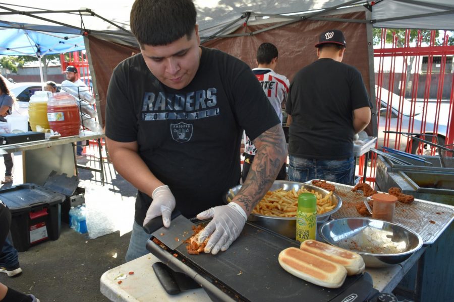 Victor Jiminez prepares loaded fries for customers on Rumrill Street at a pop-up location of Loaded Chickn on Oct. 5.