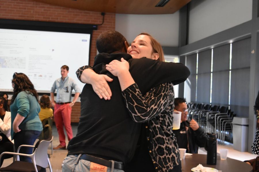 EOPS/Care CalWORKs Manager George Mills hugs Brandy Howard (right) during a brunch and ceremony in Fireside Hall on Oct. 11.