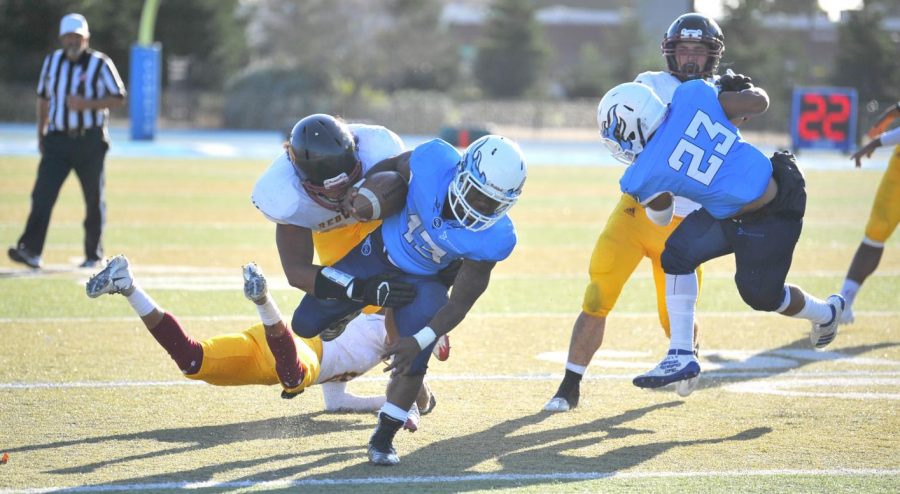 Comet+running+back+Jerald+Daniels+splits+two+Redwoods+players+before+being+tackled+on+Saturday.