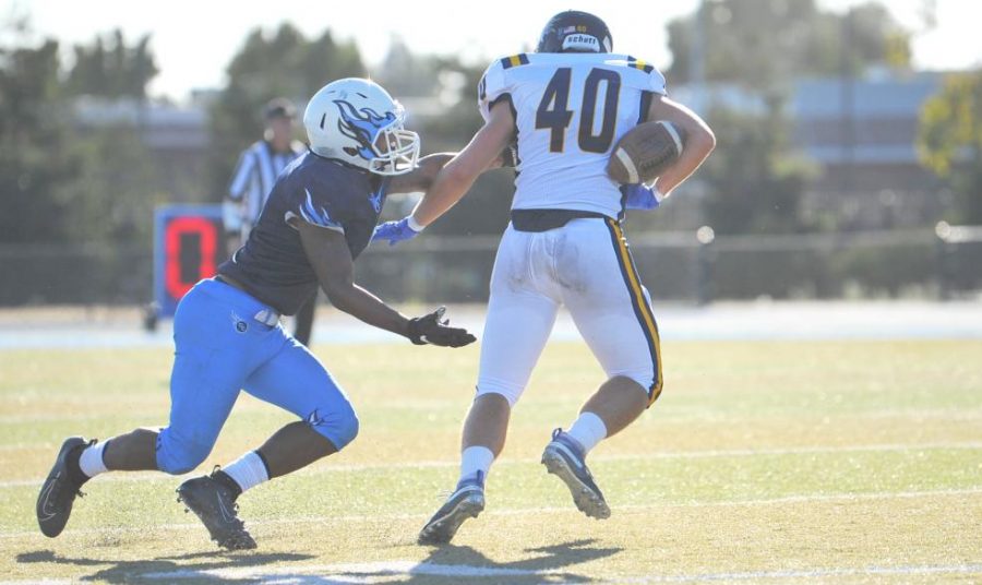  Comet  defensive
back Dayvonne Greenwood (left) flicks the ball from Merced College running back Daniel Davis
(right) who fumbles the ball during the third quarter of the Blue Devils 21-2 win over Contra Costa College at Comet Stadium on Saturday. 