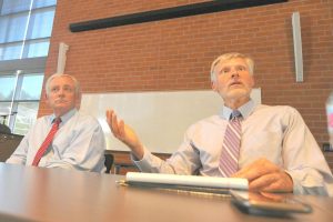 Interim Chancellor Eugene Huff (right) and Former Chancellor Fred Wood (left) discuss the formation of an interim presidential hiring committee at a Fireside Hall meeting with CCC staff on Aug. 15, 2019 during a public forum. 