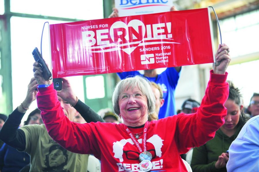 An attendee holds up a 2016 Sanders campaign sign reading “Nurses for Bernie” during a rally at Richmond’s Craneway Pavilion on Monday. 
Sanders’ campaign policies have not changed much from his 2016 campaign, and have been adopted by many of his democratic rivals. 