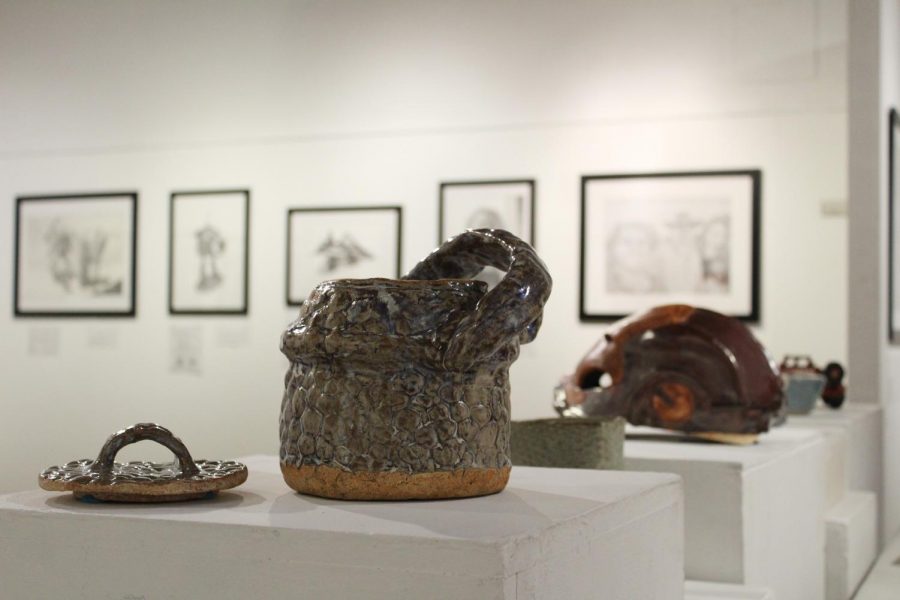 Drawings and sculptures created by Steven Berndt are pictured from left to right — ceramic baskets, a replica Iron Man mask, a ceramic bowl and a replica of Cobra Jeep from the G.I. Joe franchise. This artwork is available for viewing at the Eddie Rhodes Gallery in A-5.