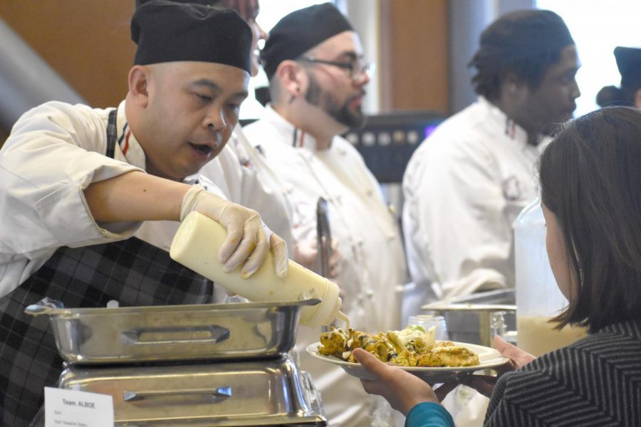 A hungry student is served by a chef at the spring semester culinary arts Iron Chef Competition on Feb. 6