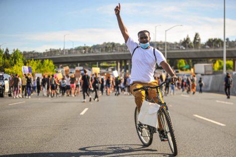 San Francisco resident Dav Gerald raises his hand in the air as he cruises on northbound Interstate 680 lanes shut down in Walnut Creek, California on June. Gerald is not part of any particular organization, but has been participating in any protest he can attend. 