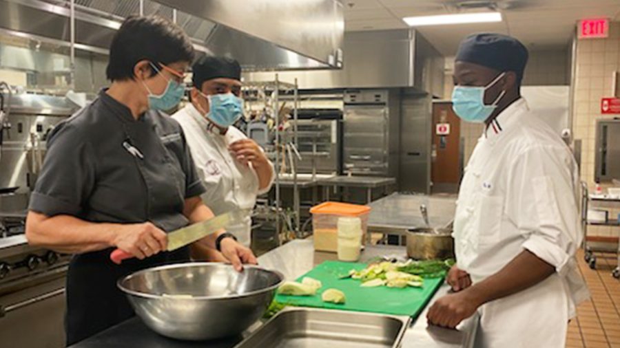 Culinary arts professor Elisabeth Schwarz teaches students cutting techniques during a face-to-face class in the Aqua Terra Grill kitchen on Sept. 26.