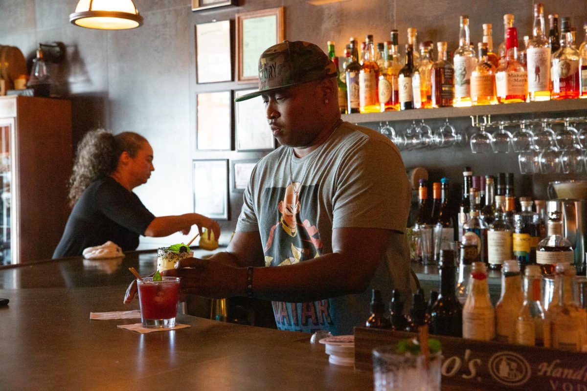 Jeremy Newton laughs, chats, and mixes drinks at The Factory Bar in Richmond, Calif. on Sunday, September 10, 2023.