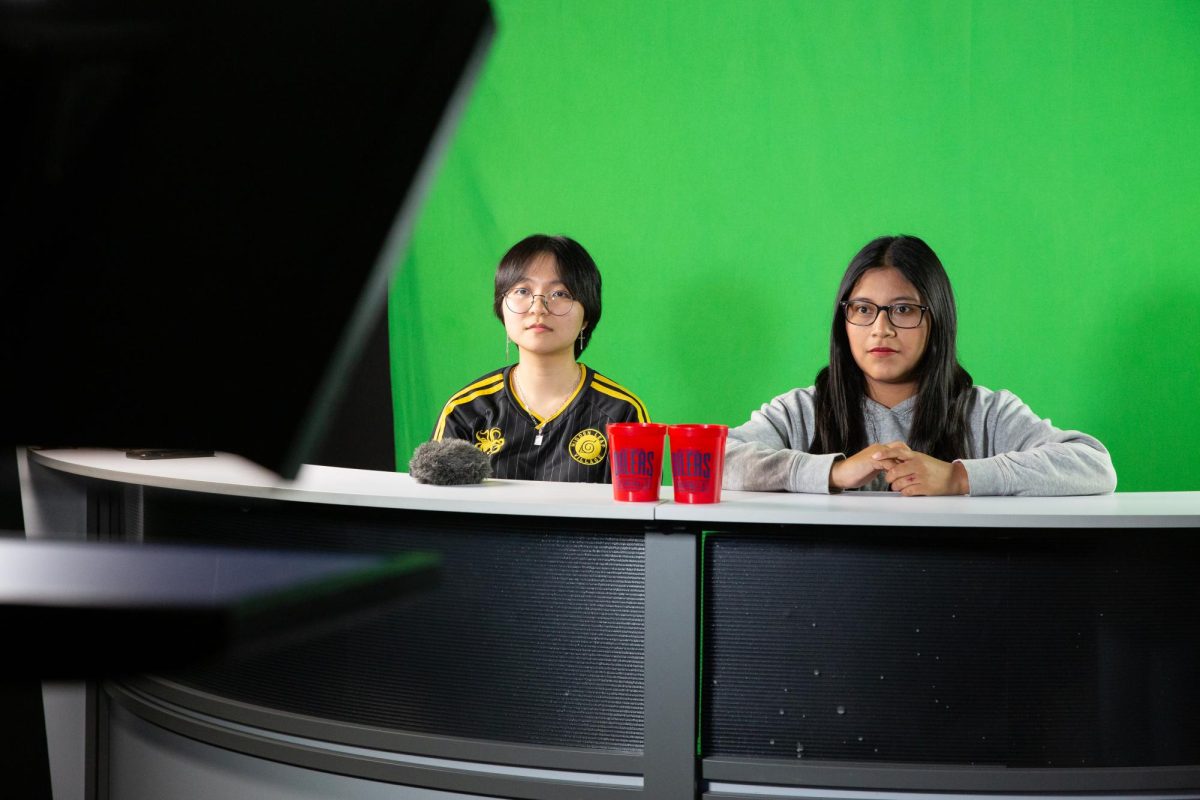 Kailani Chao, 17, left, and Daylin Martin, 18, right, seniors at Richmond High School, take on the role of news anchors as part of their Broadcast Journalism class on 0ct. 11, 2023, in Richmond, Calif. 