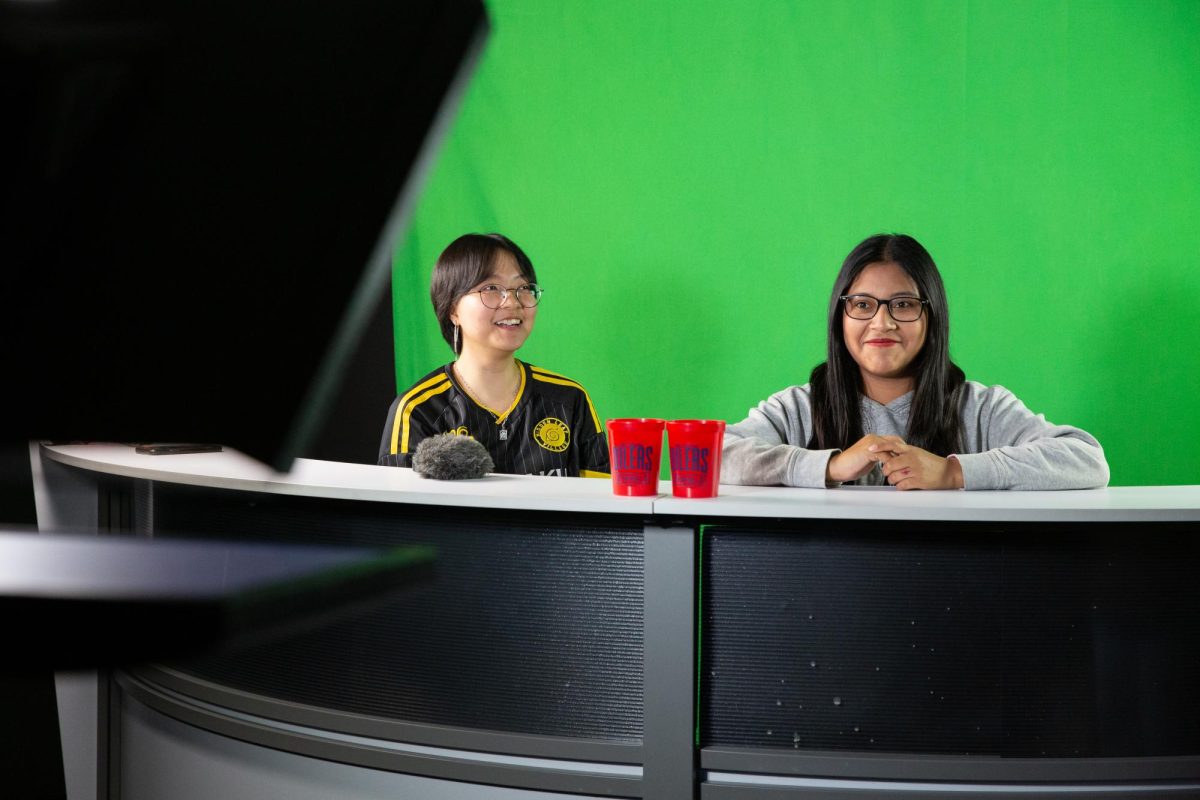 Kailani Chao, 17, left, and Daylin Martin, 18, right, seniors at Richmond High School, take on the role of news anchors as part of their Broadcast Journalism class on 0ct. 11, 2023, in Richmond, Calif. 