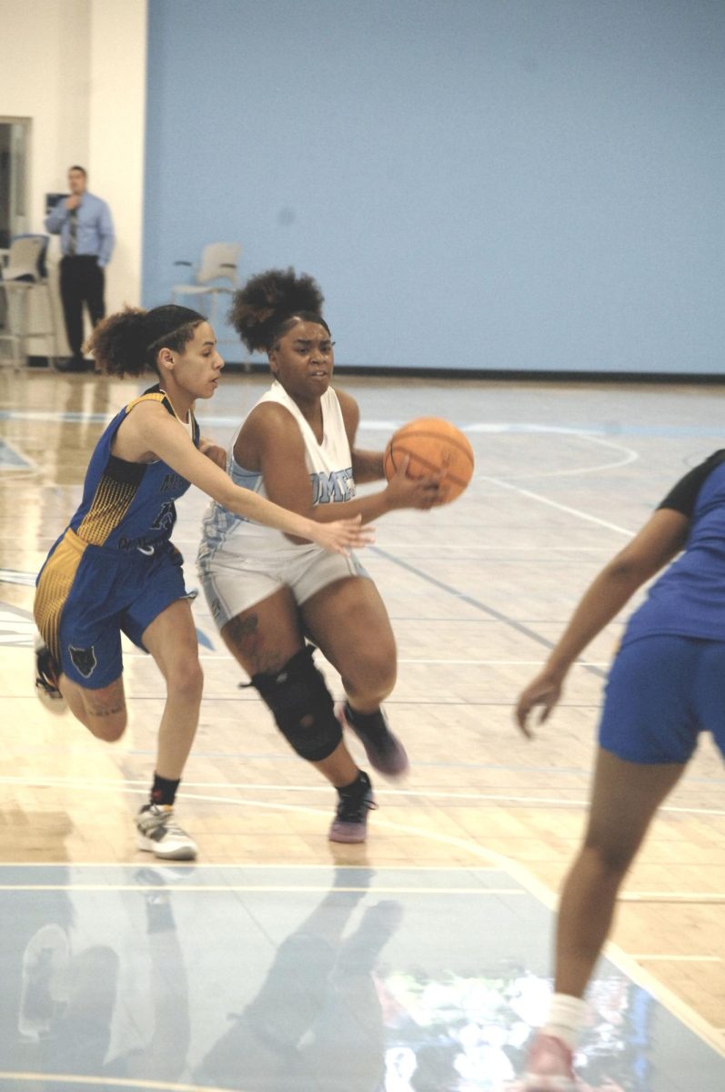 Contra Costa Comet player no#. 32 displays drive and force in making the points.

San Pablo Ca 26 January 2024, Contra Costa College, Women vs. Merritt College Women Basketball game.  
