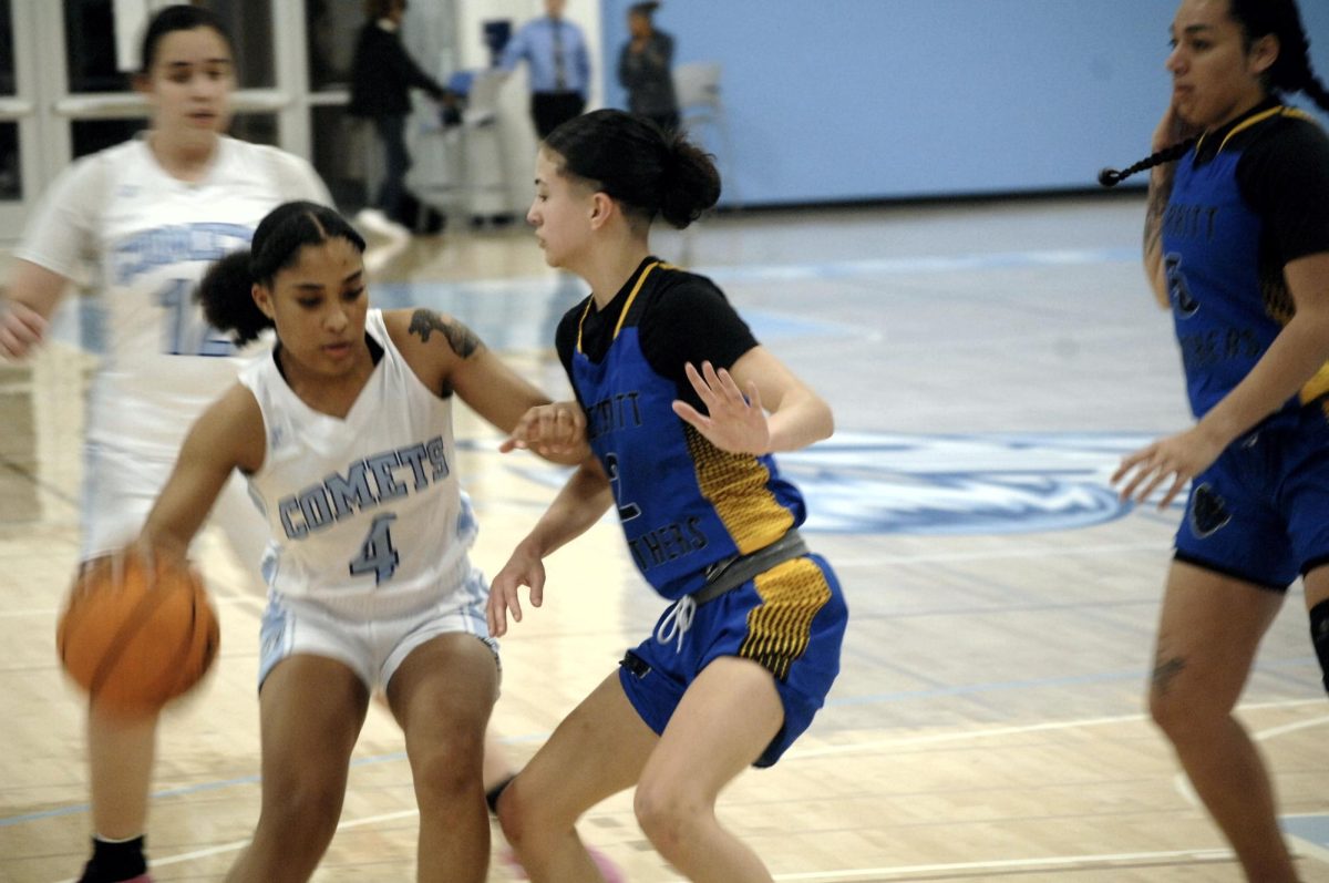 Lady Comet #4, drives her way through Merritt College players to make another point at the Contra Costa College vs Meritt College game in San Pablo, CA, on Friday, January 26, 2024.