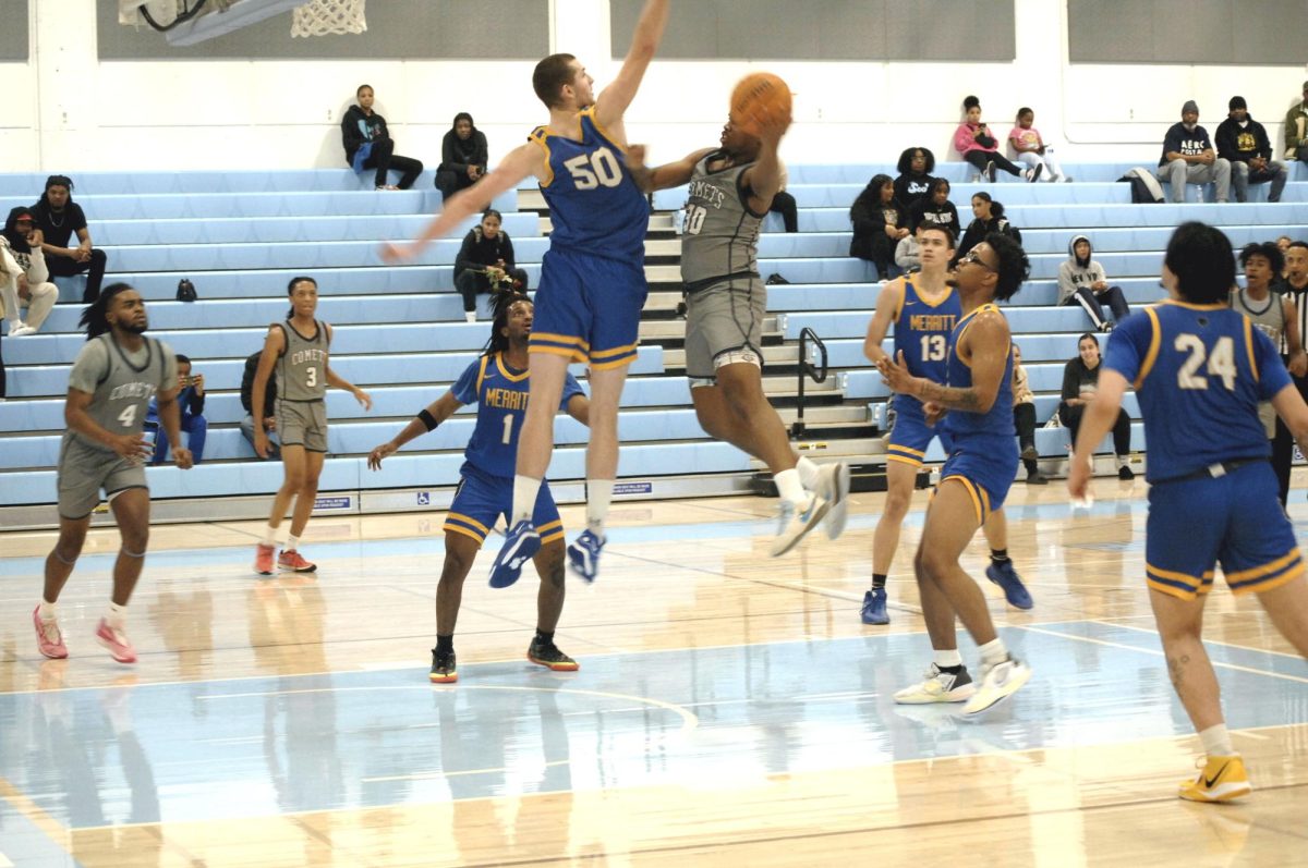 Contra Costa Comet player no#. 10 Joseph Gould, PG become airborne, in scoring more points, as Merritt College player tries to block the shot.
 
San Pablo Ca 26 January 2024, Contra Costa College, Men’s Basketball game vs. Merritt College 
