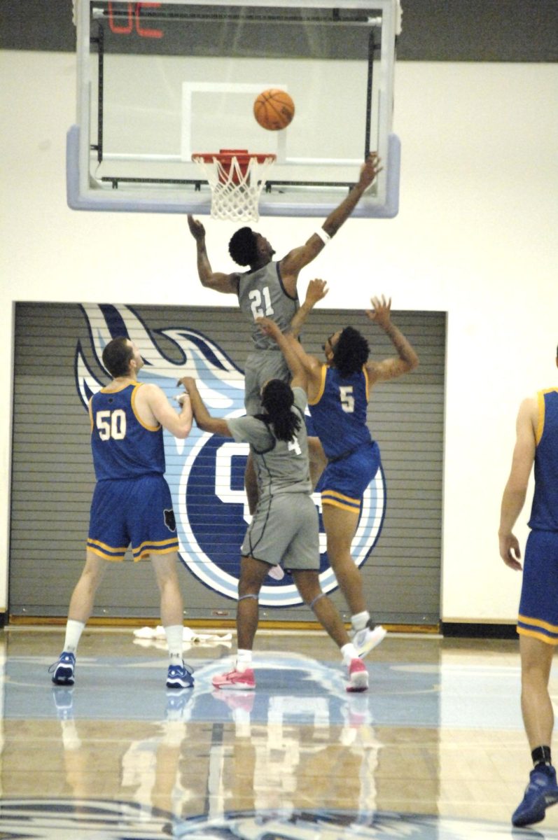 Contra Costa Comet player no#. 21 W Christopher  Sanders raises for the rebound over the Merritt College players, with the support of Contra Costa Comet player no#. 4 G Prime Payton.
 
San Pablo Ca 26 January 2024, Contra Costa College, Men’s Basketball game vs. Merritt College 
