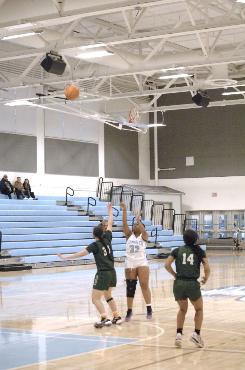 The Lady Comet player, No.# 32 shows the ease of a three-pointer. Contra Costa College, Womens Basketball game vs. Laney College, San Pablo Ca 22 February 2024
