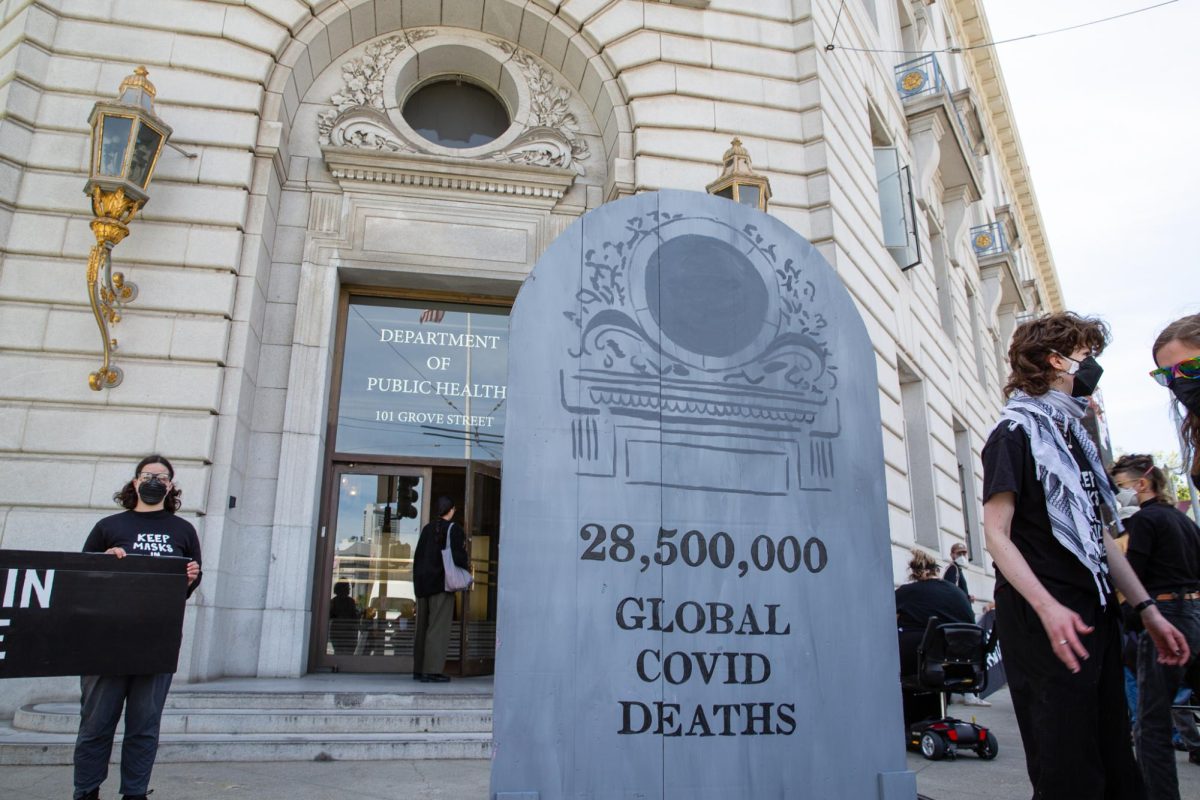 Demonstrators hold banners and signs outside the San Francisco Department of Public Health on April 16, 2024.