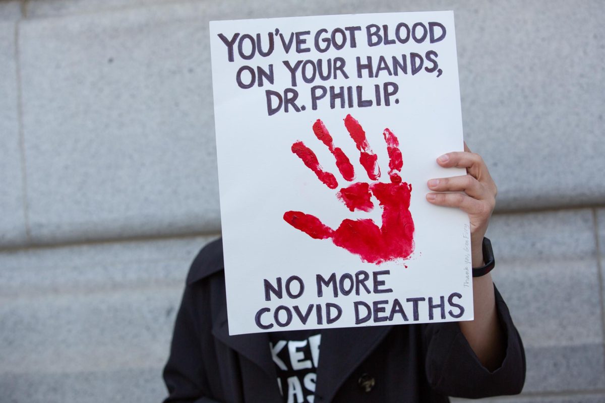 A demonstrator holds up a sign addressing Dr. Susan Philip, San Francisco Health Officer, outside the San Francisco Department of Public Health building on April 16, 2024 in San Francisco, Calif.