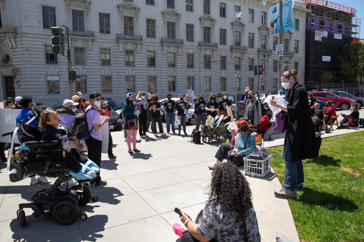 Elizabeth, a member of Senior and Disability Action, addresses the crowd gathered for a Keep Masks in Health Care demonstration outside San Francisco City Hall on April 16, 2024 in San Francisco, Calif. 