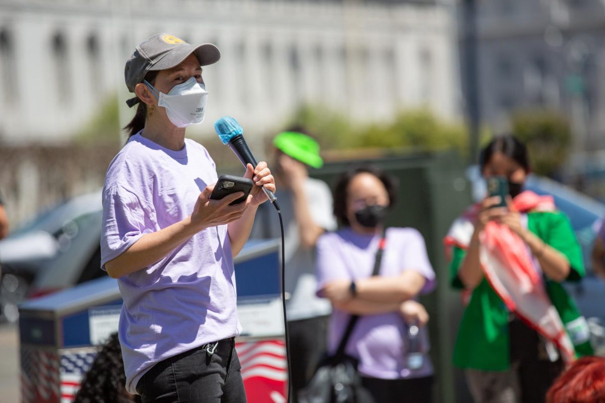 Jasmin Hoo, of the organization Lavender Phoenix, speaks to fellow demonstrators outside San Francisco City Hall on April 16, 2024 in San Francisco, Calif. 