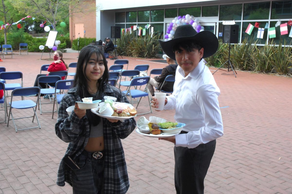 Some students are seen enjoying themselves during the Middle College High School Culture Night in Richmond, Calif., on Thursday, April 25, 2024. As they get ready to dive into their plates of food.