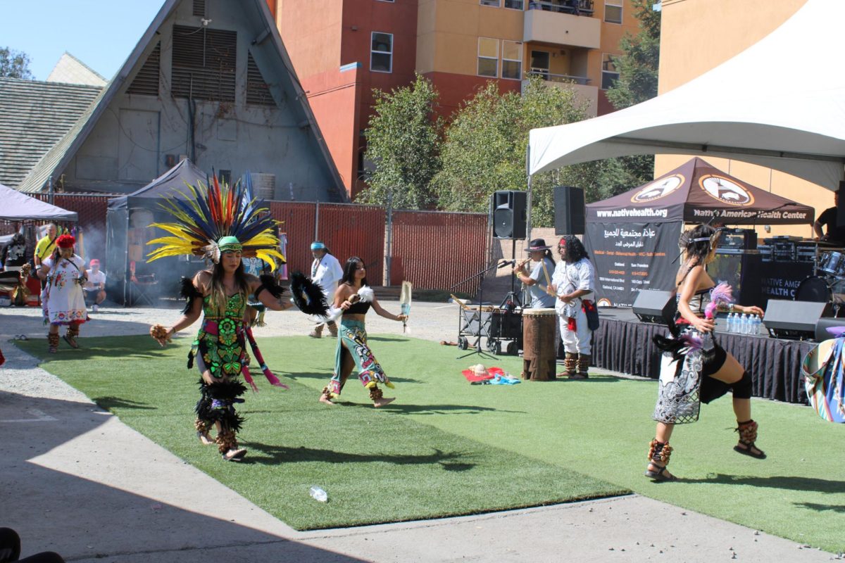 Calpulli Coatlicue perform the Welcome dance at the Indigenous Red Market in Derby Ave. in Oakland, Calif., on Oct. 6,2024