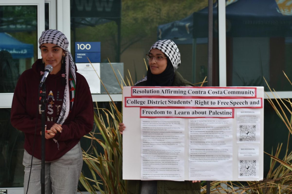 Sophie and Eman showing the Resolution for Free Speech in the Contra Costa Community. At Contra Costa College, San Pablo, Calif. Nov. 