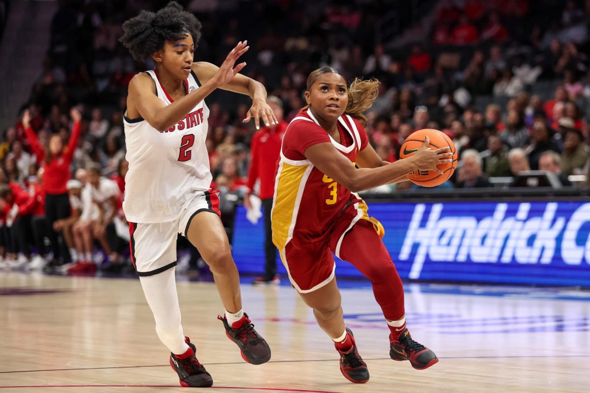 Nov 9, 2025; Charlotte, North Carolina, USA; Southern California Trojans guard Londynn Jones (3) battles for position against NC State Wolfpack guard Qadence Samuels (2) during the third quarter of the Ally Tipoff game at Spectrum Center. Cory Knowlton-Imagn Images
