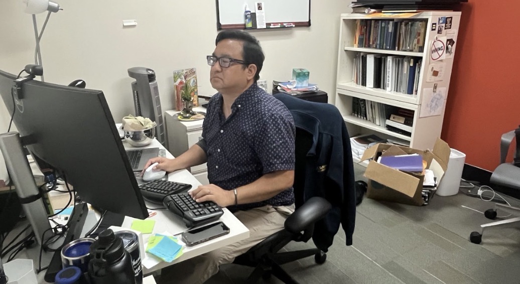 Rod Santos works at his desk at Contra Costa College. The district eliminated his position as dean of enrollment services as part of budget cuts. (Duha Hmidan/The Advocate)
