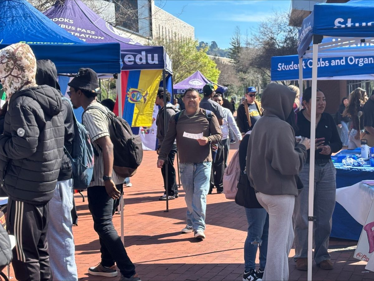CCC Student walking through Club Rush in the quad with bingo card in hand. Student attendees were incentivized with a free lunch for filling their bingo cards with stamps from different clubs and/or organizations. 