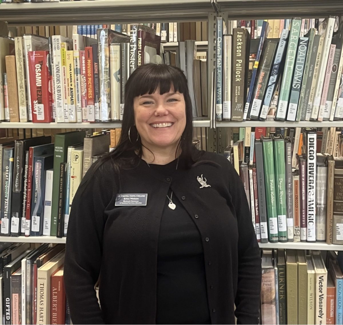 Erica Watson, standing by the library’s books.( Zoe Hardwood/ The Advocate)