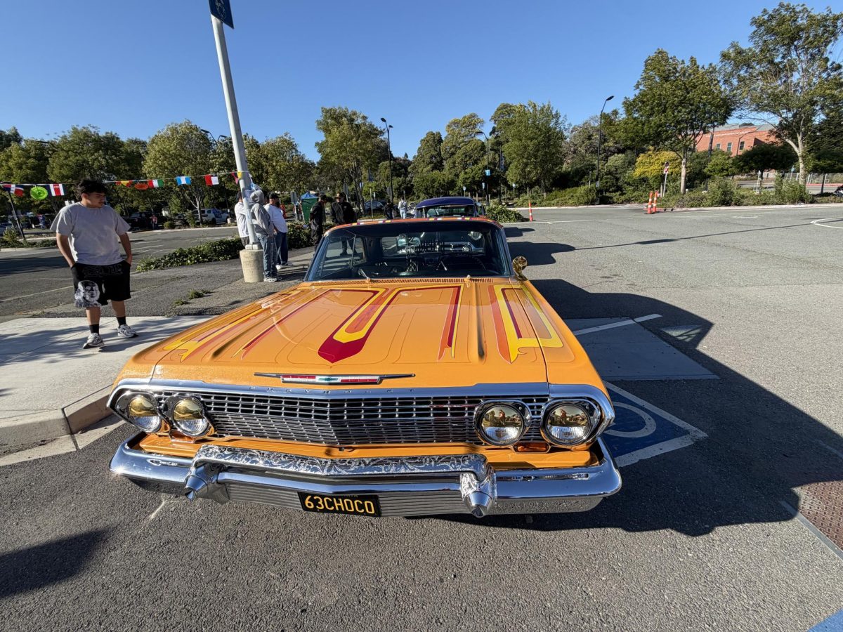 bright oranage with yellow and red stripes chevrolet at CCC parking lot 6 on Friday May 8, 5:53p.m. 