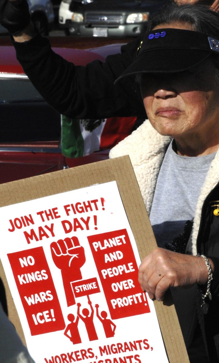 A supporter holds a sign at a May Day rally along San Pablo Dam Road and Appian Way in El Sobrante, Calif., on Friday, May 1, 2026. (Leon Watkins/The Advocate)