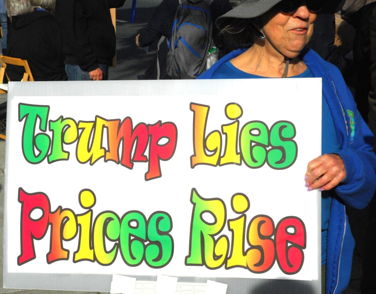 A supporter holds a sign at a May Day rally along San Pablo Dam Road and Appian Way in El Sobrante, Calif., on Friday, May 1, 2026. (Leon Watkins/The Advocate)